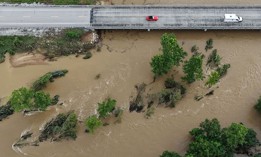High water levels submerge trees along a bridge on Route 21 on the Black River due to flash flooding in Centerville, Missouri, and the surrounding region on Friday, July 10, 2026.