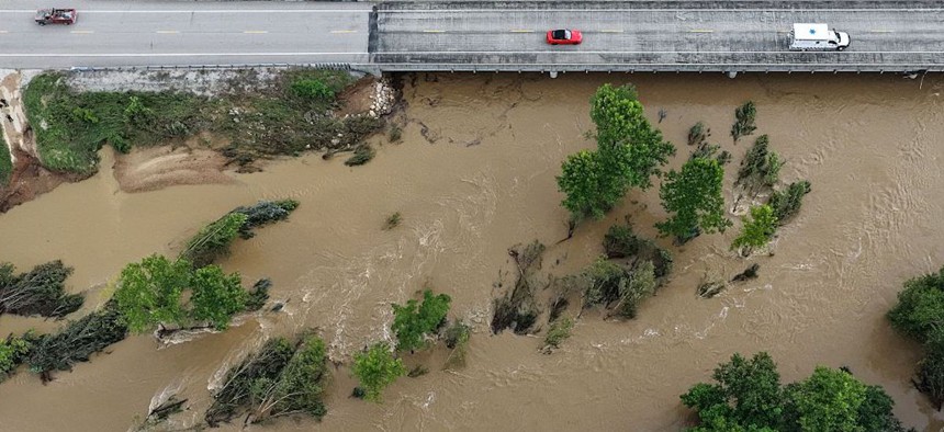 High water levels submerge trees along a bridge on Route 21 on the Black River due to flash flooding in Centerville, Missouri, and the surrounding region on Friday, July 10, 2026.