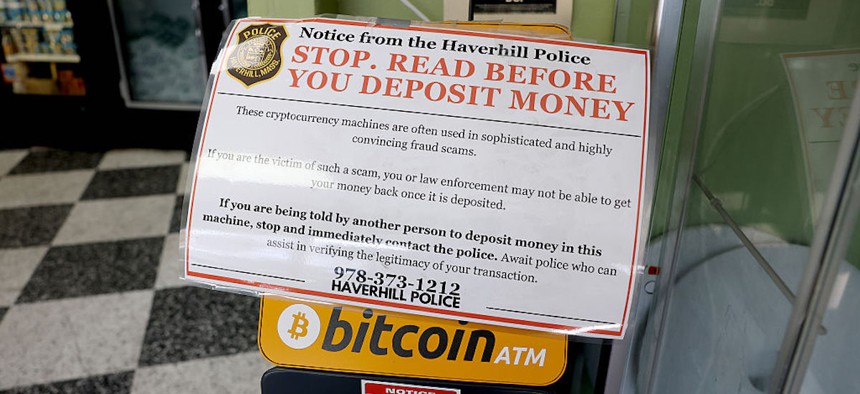 A sign was taped to the top of a bitcoin ATM inside Sam's Food Store on April 6, 2026, in Harverhill, Massachusetts.