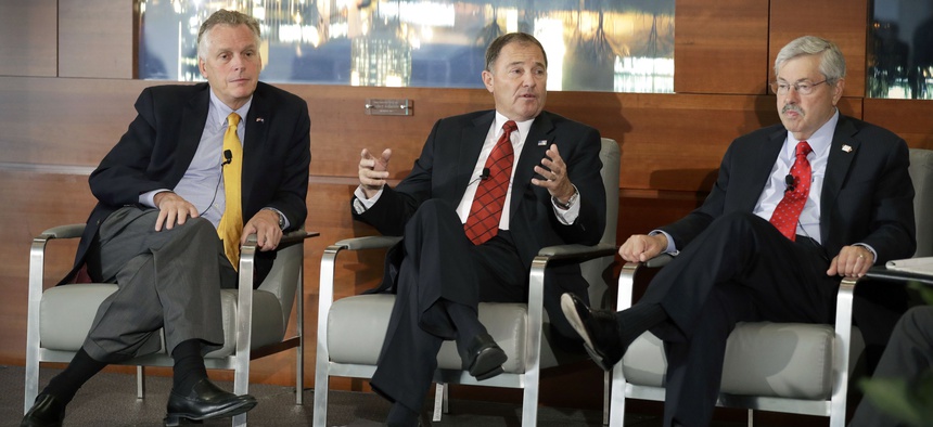 Utah Gov. Gary Herbert, center, speaks during a session at the National Governors Association meeting as Virginia Gov. Terry McAuliffe, left, and Iowa Gov. Terry Branstad, right, look on, Friday, July 15, 2016, in Des Moines, Iowa.