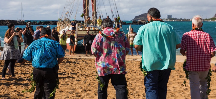 From left to right: Maui County Mayor Alan Arakawa, Hawaii County Managing Director Wil Okabe, Kauai County Mayor Bernard Carvalho Jr., and Honolulu Mayor Kirk Caldwell approach the Polynesian voyaging canoe Hōkūleʻa ahead of signing their proclamations.