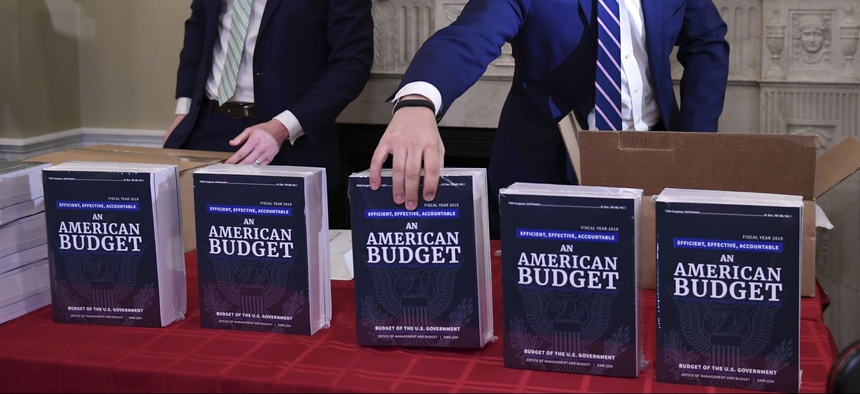 James Knable, left, and Jeffrey Freeland, right, help to unpack copies of the President's FY19 Budget after it arrived at the House Budget Committee office on Capitol Hill in Washington, Monday, Feb. 12, 2018.