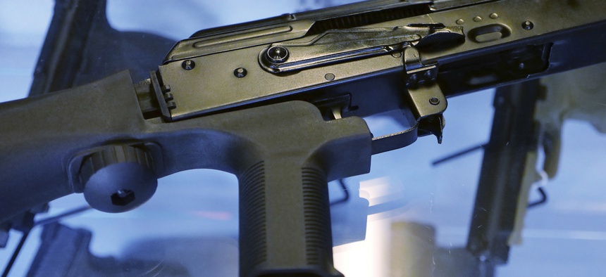 In this Oct. 4, 2017, photo, a device called a "bump stock" is attached to a semi-automatic rifle at the Gun Vault store and shooting range in South Jordan, Utah.