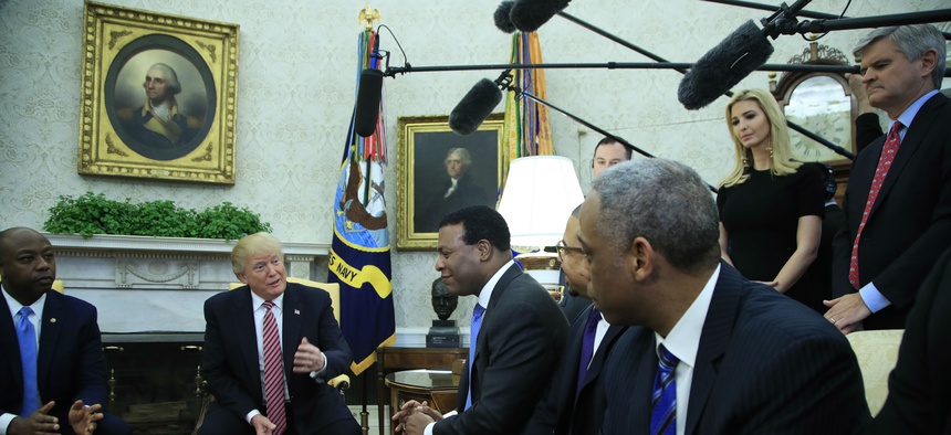 President Donald Trump, with Sen. Tim Scott, R-S.C., left, Ivanka Trump, top second from right, and Steve Case, top right, participate in a working session regarding the opportunity zones provided by tax reform in the Roosevelt Room of the White House.