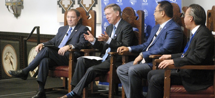 From left to right, Republican Utah Gov. Gary Herbert, Democratic Colorado Gov. John Hickenlooper, International Vitamin Corp. CEO Dai Ming, and Jushi USA Fiberglass CEO William Woo talk about trade in Santa Fe, New Mexico.