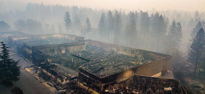 Smoke hangs over the scorched remains of Old Town Plaza following the wildfire in Paradise, California.