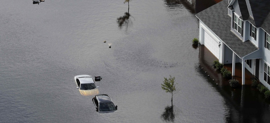 Cars are submerged in a neighborhood in the aftermath of Hurricane Florence in Fayetteville, N.C., Monday, Sept. 17, 2018.