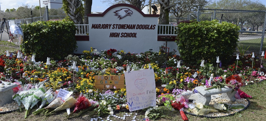 Students and parents visit a make shift memorial setup at Marjory Stoneman Douglas High School in honor of those killed during a mass shooting to mark the one year anniversary on Feb. 14, 2019.