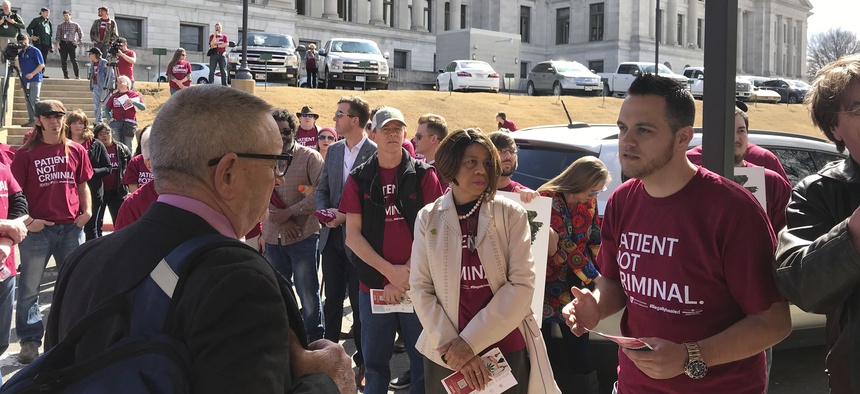 Corey Hunt with the Arkansas Cannabis Industry Association talked with state Rep. Douglas House outside the Arkansas State Capitol on Feb. 27, 2018 about changes the group wanted to the state's medical marijuana program.