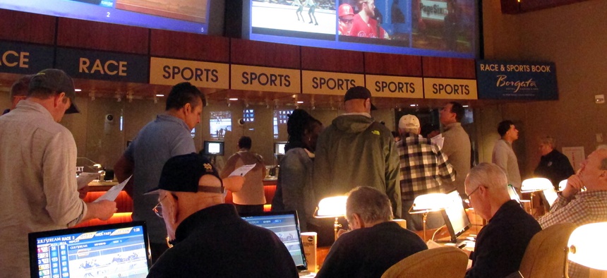 Gamblers line up to place bets on the NCAA men's college basketball tournament at the Borgata casino in Atlantic City N.J., on March 21, 2019.