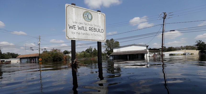 A sign commemorating the rebuilding of the town of Nichols, which was flooded two years earlier from Hurricane Matthew, stands in floodwaters in the aftermath of Hurricane Florence in Nichols, S.C. in 2018.
