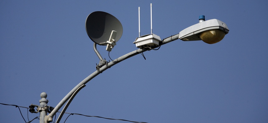 A transmitter with two antennas for wireless, high-speed Internet is seen strapped to a light pole on a residential street, Wednesday, May 16, 2007 in Lompoc, California.