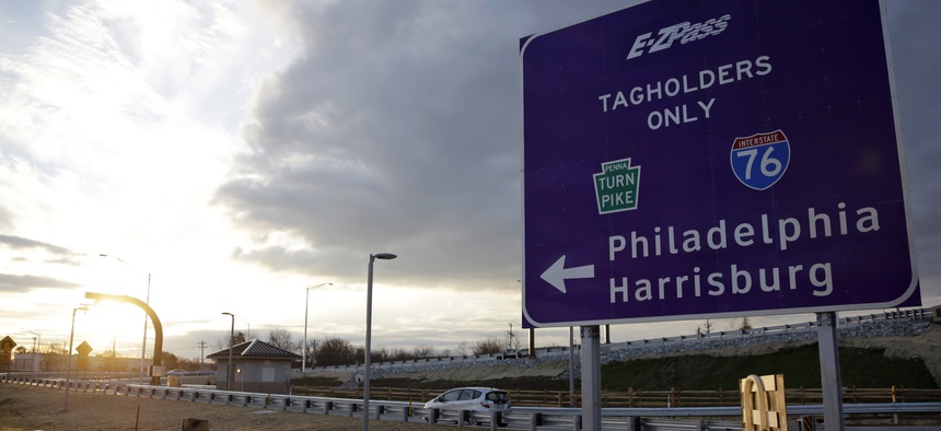 In this file photo taken Dec. 11, 2012, a driver enters the Pennsylvania Turnpike at a newly completed E-ZPass Only electronic interchange in Malvern, Pa.