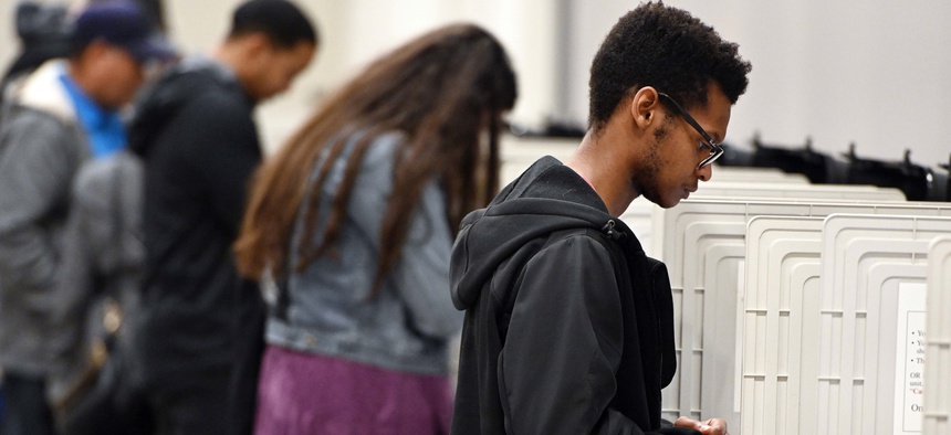 In this Oct. 27, 2018 file photo, people cast their ballots ahead of the Nov. 6, general election at Jim Miller Park in Marietta, Ga.