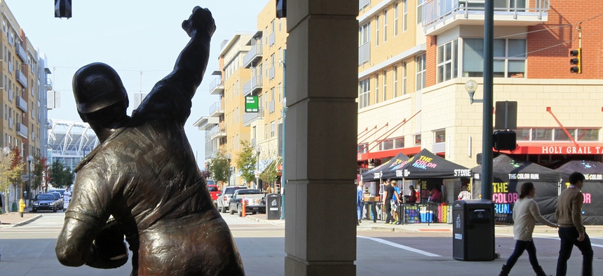A statue of Cincinnati Reds Hall of Fame catcher Johnny Bench stands outside Great American Ballpark looking towards the restaurants and condominiums that have sprung up around the home of the Reds in Cincinnati.