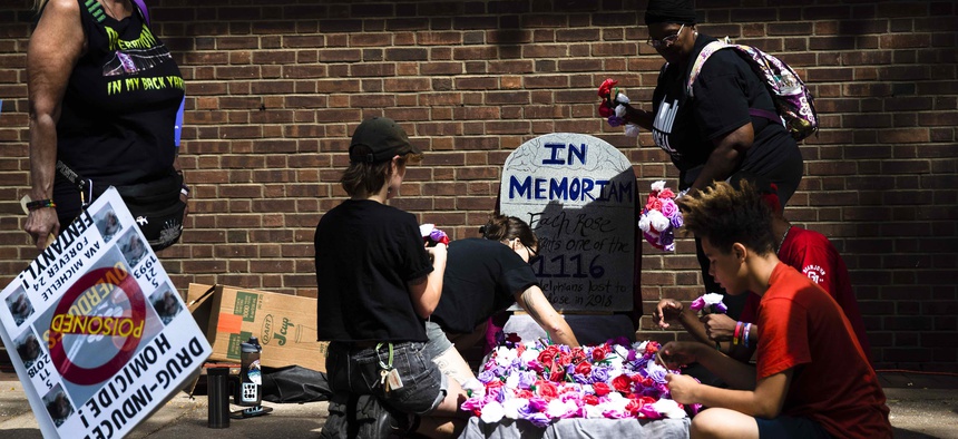 Protesters assemble a makeshift memorial to those lost to drug overdoses last year during a demonstration in support of a proposed supervised injection site, outside the federal courthouse in Philadelphia, Thursday, Sept. 5, 2019.