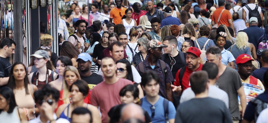 In this Aug. 22, 2019, photo, people walk through New York's Times Square. With just a few months left before America starts taking its biggest-ever self-portrait, the U.S. Census Bureau is grappling with a host of concerns about the headcount.