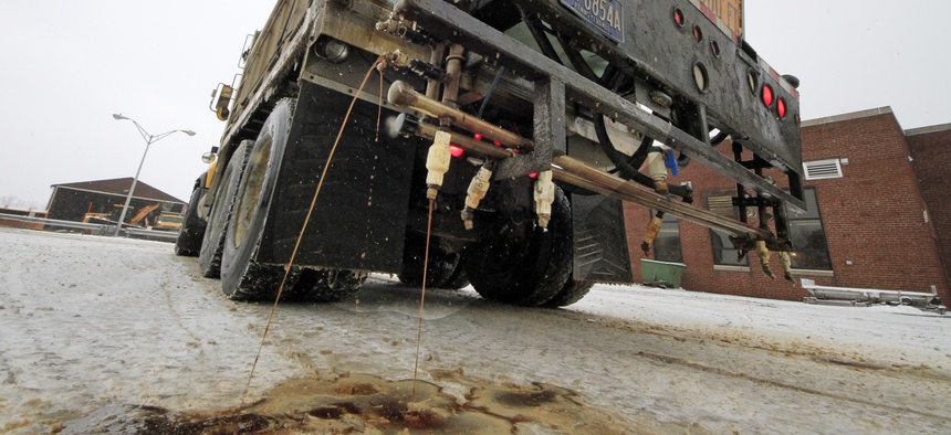 In a demonstration, a Pennsylvania Department of Transportation anti-icing truck sprays a de-icing cocktail of brine and beet juice on the driveway of PennDot's Butler, Pa., maintenance facility, Monday, Jan. 6, 2014.