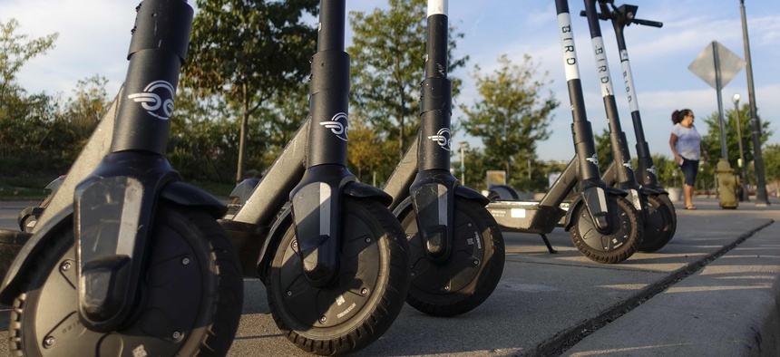 Sharable electric scooters by Bird Rides, Inc. wait on downtown sidewalks for pedestrian use, Wednesday, Oct. 2, 2019, in downtown Cincinnati.