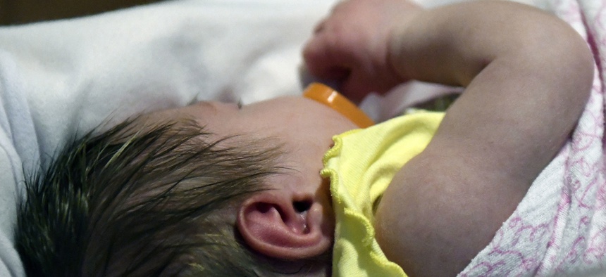 A week-old baby lies in a neonatal intensive care unit dedicated to newborns of opioid addicted mothers at the Norton Children's Hospital in Louisville, Ky.