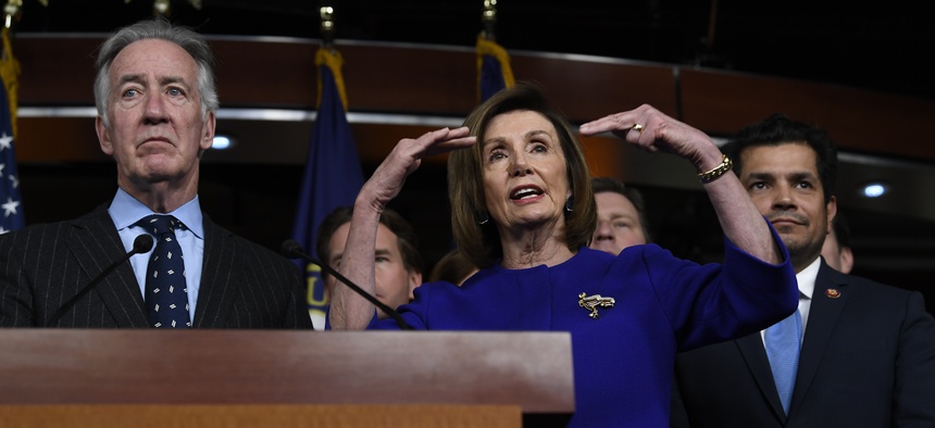 House Speaker Nancy Pelosi of Calif., accompanied by House Ways and Means Committee Chairman Richard Neal, D-Mass., speaks at a news conference on Capitol Hill in Washington, Tuesday, Dec. 10, 2019, on Capitol Hill in Washington.
