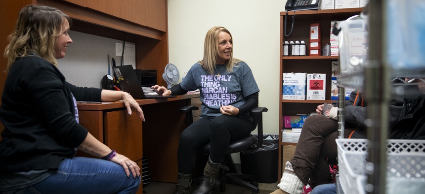 Charmin Gabbard (center) and Darci Moore (left) gather information from two participants at the syringe exchange run by Fayette County Harm Reduction Alliance in Connersville, Indiana, on Jan. 23, 2020. The exchange had reopened the day before.