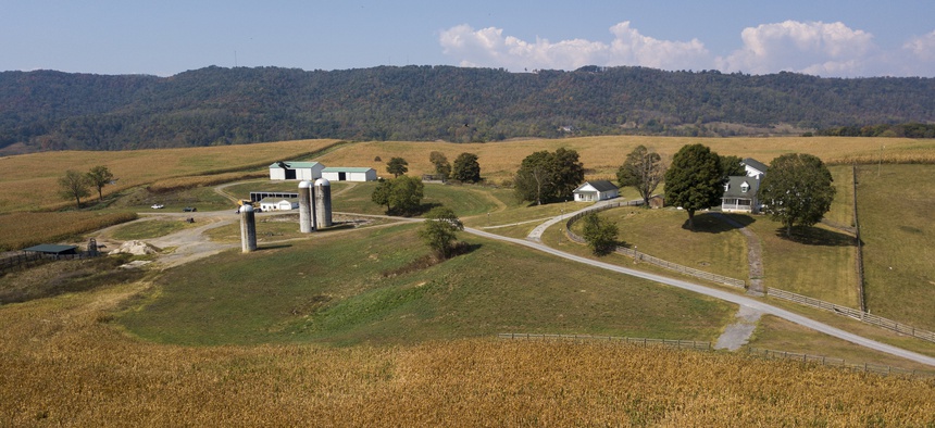 This Oct. 1, 2019 aerial photo shows farm buildings and a farm house surrounded by a crop of corn on a farm owned by the family of West Virginia Governor Jim Justice near Lewisburg, W.Va.