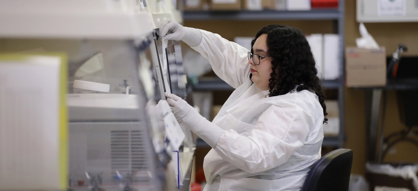 Aubrey Holland performs tests at the Bureau of Public Health Laboratories on Monday, March 2, 2020, in Miami, where the COVID-19 virus is being tested.