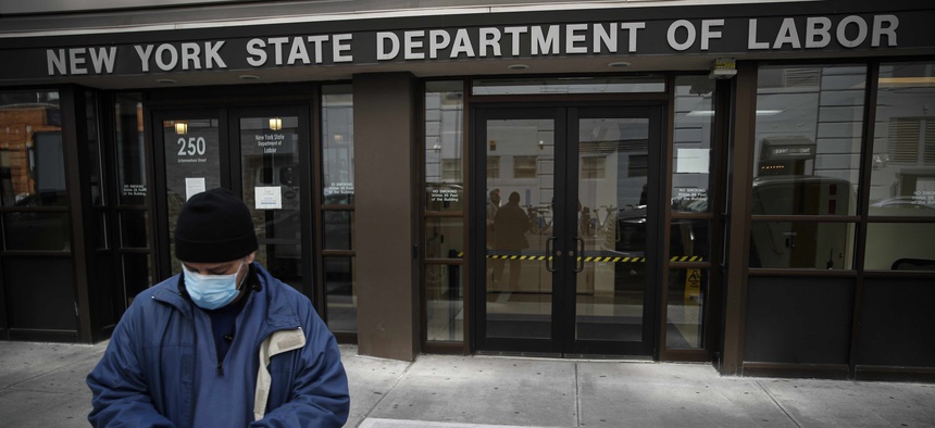 Visitors to the Department of Labor are turned away at the door by personnel due to closures over coronavirus concerns, Wednesday, March 18, 2020, in New York.