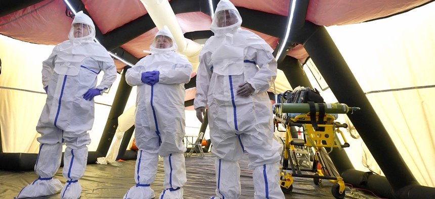Dr. Suchmor Thomas, right, wears a protective suit along with nurses Eric Bieber, center, and Kevin Anderson, inside the intensive care unit of the new Harris County Non-Congregate Medical Shelter at NRG Park Saturday, April 11, 2020, in Houston.