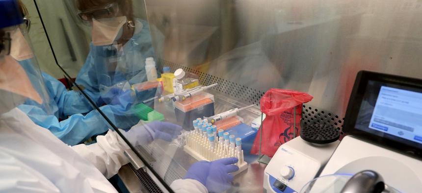 Cindy Morris, left, and Swarnamala Ratnayaka prepare RNA for testing for the new coronavirus at the molecular pathology lab at Tulane University School of Medicine in New Orleans, Thursday, April 2, 2020.
