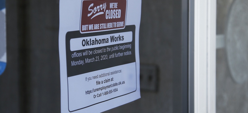 A sign at the Oklahoma Employment Security Commission offices states the offices are closed, Thursday, April 23, 2020, due to the coronavirus, in Oklahoma City.