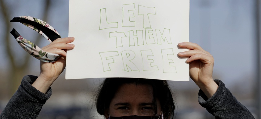 A woman protests outside Cook County Jail in Chicago, asking for the release of detainees during the pandemic.