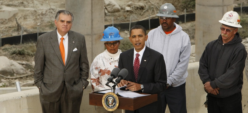 Former President Barack Obama makes remarks about the Recovery Act during a tour of the the Fairfax County Parkway extension project in Springfield, Va. on Oct. 14, 2009. Former Transportation Secretary Ray LaHood is at left.