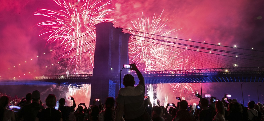 People on the east side of Manhattan watch a fireworks display, part of Independence Day festivities, Thursday, July 4, 2019, in New York.