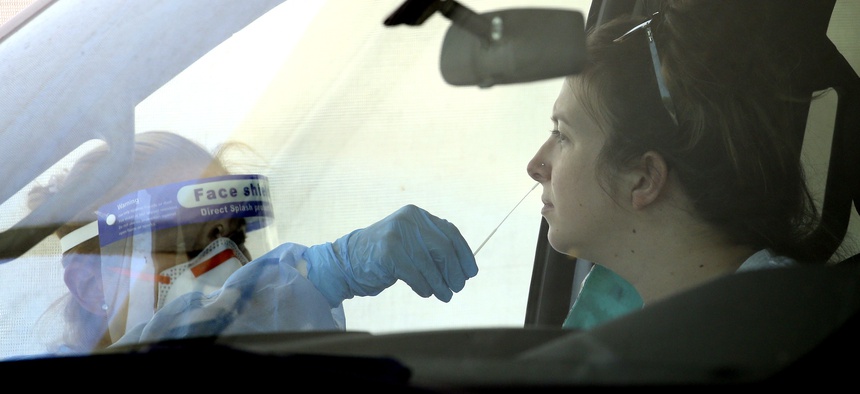 People get tested at a drive thru coronavirus testing site at South Mountain Community College, Thursday, July 9, 2020, in Phoenix.