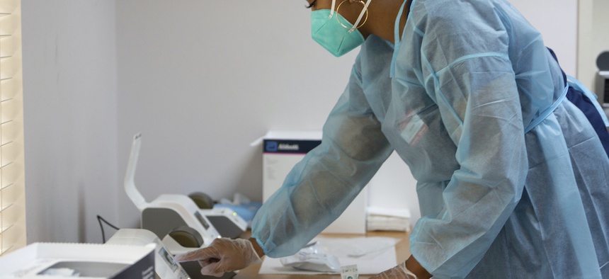 Alysses Goree, CVS Pharmacy Technician, processes a rapid Covid-19 test at the Ibn Sina Foundation Community Clinic on Saturday, July 18, 2020, in Houston.