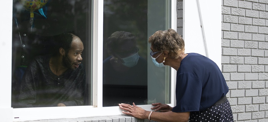Southern Pines nursing home resident Wayne Swint gets a birthday visit from his mother, Clemittee Swint, in Warner Robins, Ga. in June. Staff members at facilities across the country are arranging window visits as face-to-face visits remain off-limits.