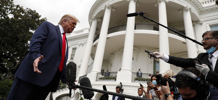 President Donald Trump speaks with members of the media before boarding Marine One on the South Lawn of the White House in Washington, Thursday, Aug. 6, 2020, for a short trip to Andrews Air Force Base, Md. and then on to Cleveland, Ohio.