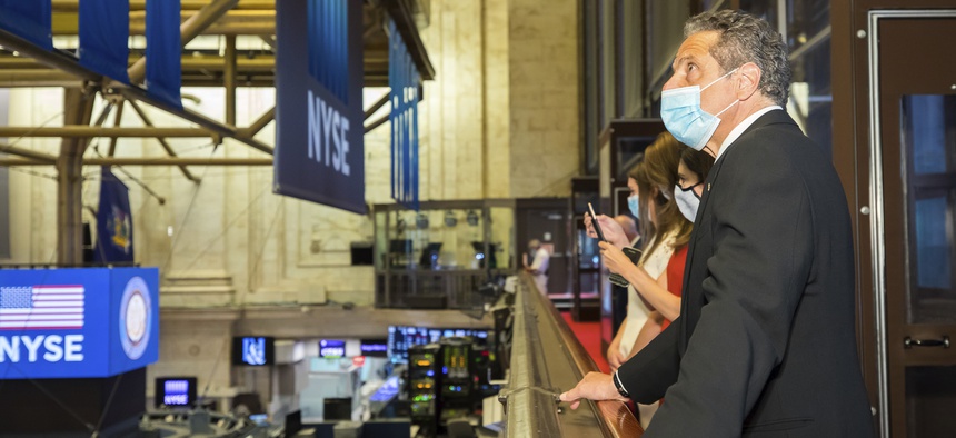 New York State Gov. Andrew Cuomo rings the opening bell with New York Stock Exchange President Stacey Cunningham to mark the historic reopening of the NYSE Trading Floor on May 26, 2020, in New York.