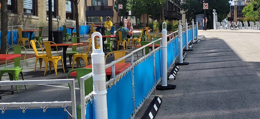 Outdoor dining areas spill into the street as part of Madison, Wisconsin's "streatery" program, designed to help local restaurants survive the ongoing Covid-19 pandemic.