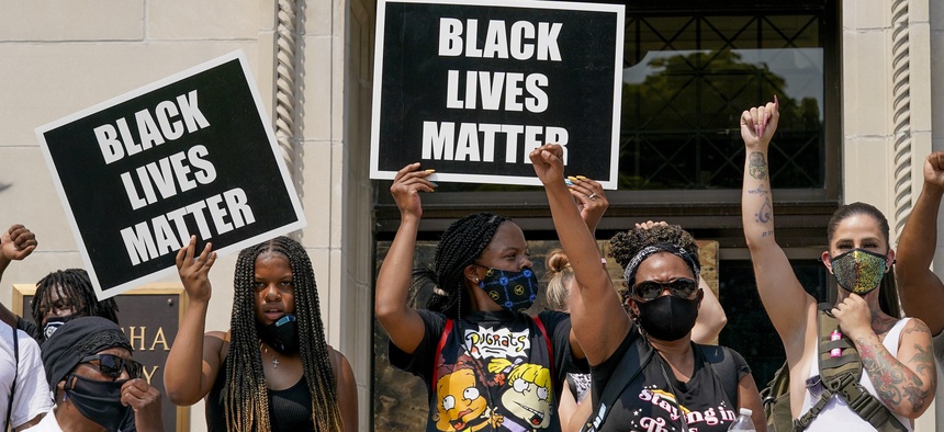 A small group of Black Lives Matter protesters hold a rally on the steps of the Kenosha County courthouse Monday, Aug. 24, 2020, in Kenosha, Wis.