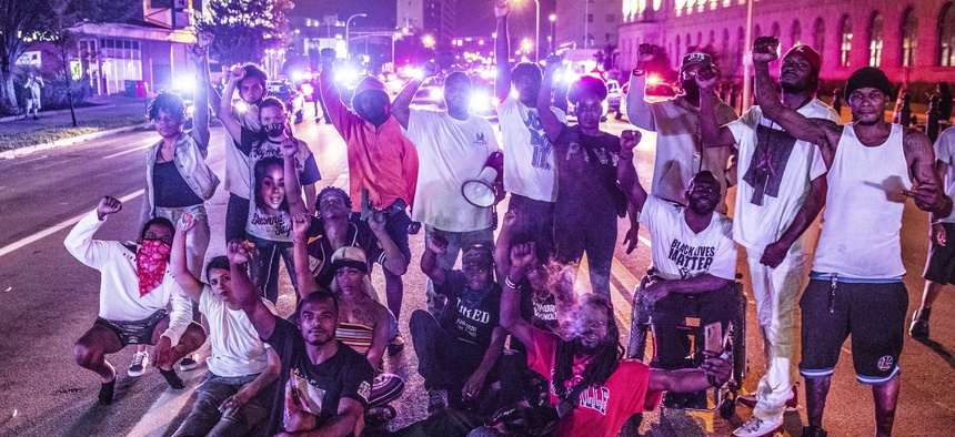 Black Lives Matter protestors demonstrate at the corner of 6th and Broadway in Louisville, Kentucky after the police shooting of Jacob Blake on August 23, 2020 in Kenosha, Wisconsin.