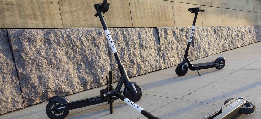 Sharable electric scooters by Bird Rides, Inc. wait on downtown sidewalks for pedestrian use, Wednesday, Oct. 2, 2019, in downtown Cincinnati.