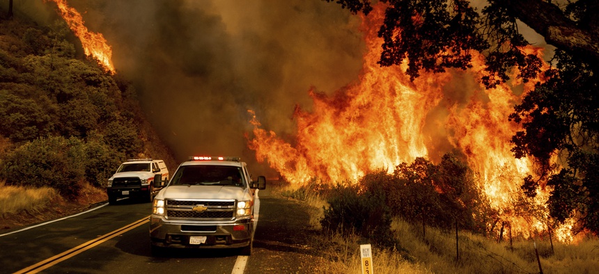 Flames from the LNU Lightning Complex fires jump Butts Canyon Rd. on Aug. 23, 2020, as firefighters work to contain the blaze in unincorporated Lake County.