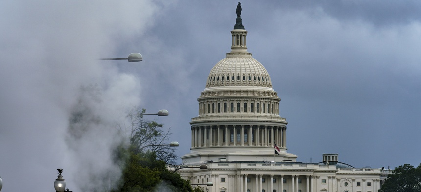 The Capitol is seen in the distance as steam clouds billow up from beneath a construction area on Pennsylvania Avenue in Washington, Thursday, Sept. 10, 2020.