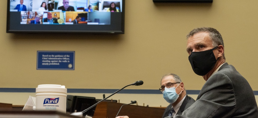 With a screen showing members of the committee and witnesses who are joining remotely, John Thompson, former director of the Census Bureau, left, and J. Christopher Mihm, with the Government Accountability Office testify before a House Oversight hearing.