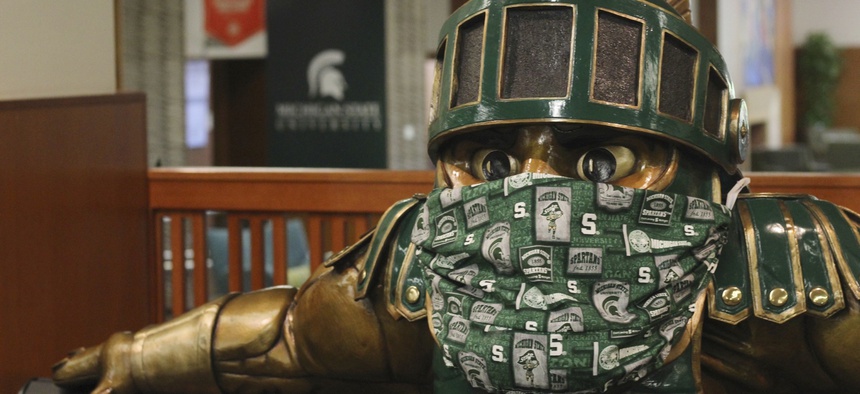 A face mask on the Sparty statue inside the the Michigan State University Student Union is seen on Aug. 21, 2020. Like other schools, Michigan State, which is online only this semester, expect to enroll fewer international students this year.