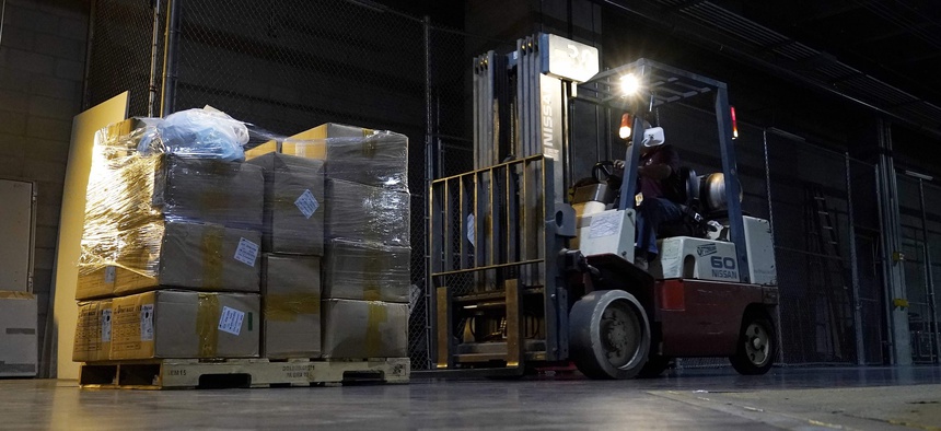 A worker with a forklift picks up a pallet of protective gear in Phoenix in early September, 2020. Personal protective equipment is one cost localities have been covering with federal aid.