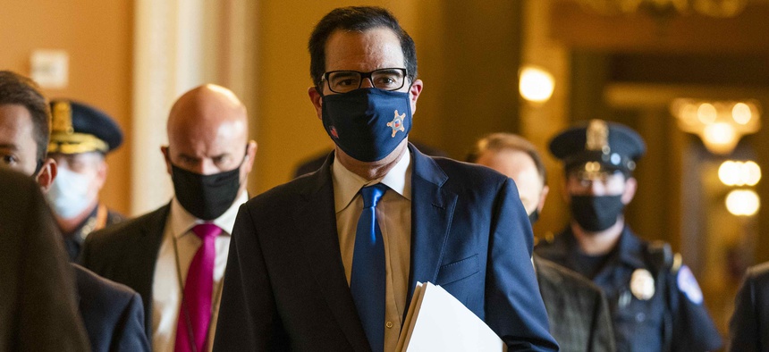 Treasury Secretary Steven Mnuchin, walks from the office of Senate Majority Leader Sen. Mitch McConnell of Ky., as he leaves the Capitol, Wednesday, Sept. 30, 2020, in Washington. Mnuchin earlier met with House Speaker Nancy Pelosi of Calif.